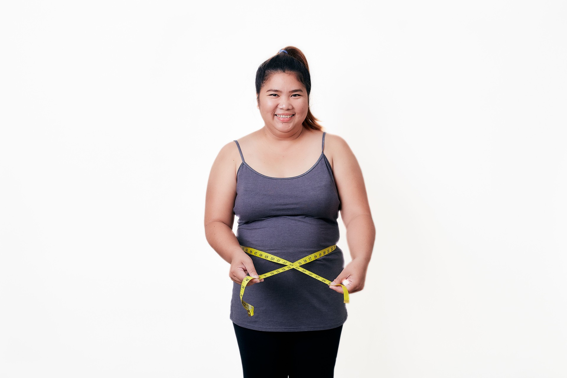 Fat woman measuring her fat belly with tape, health problems and overweight